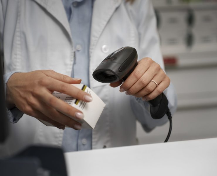 female-pharmacist-scanning-medicine-counter